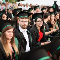 Absolvenți fericiți în timpul ceremoniei de absolvire